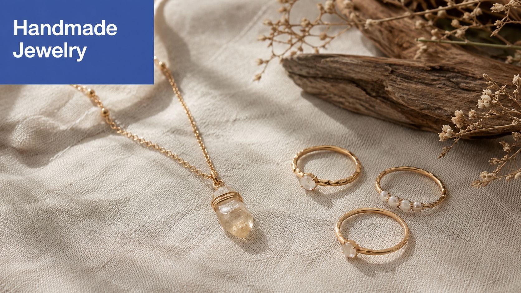 An elegant gold necklace with a raw crystal pendant and three matching gold rings on fabric.
