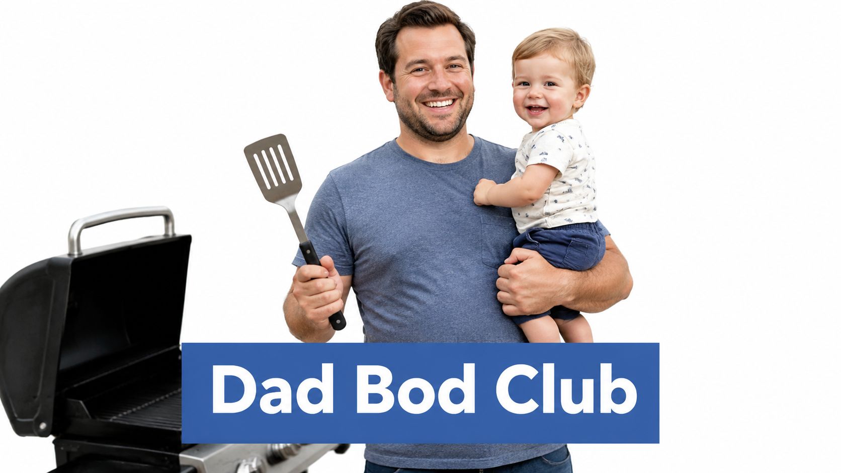 A happy father holding his toddler while holding a grilling spatula near a barbecue grill.